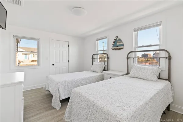 a bedroom with a bed and a flat screen tv
