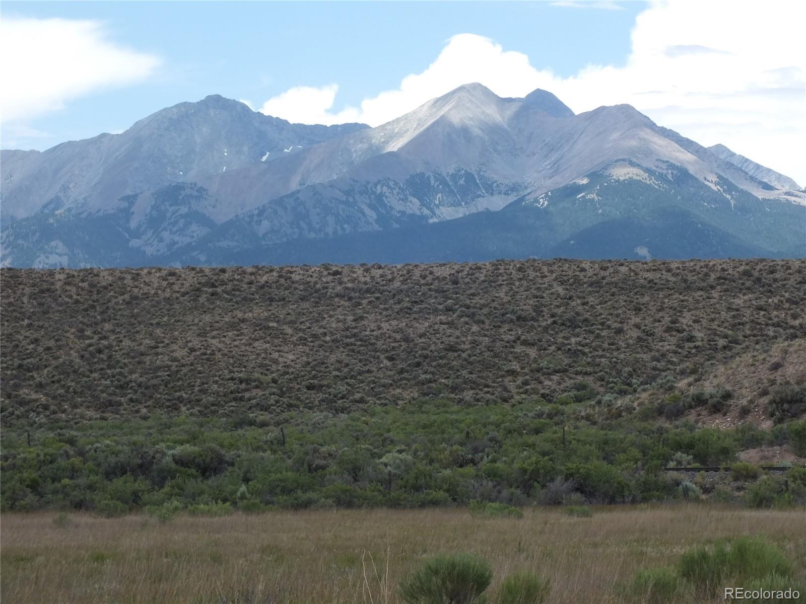 0 Casey Road Fort Garland, CO 81133 - Photo 11 of 11 a view of a lush green hillside and a building