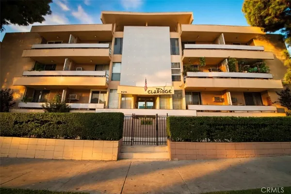 a front view of a building with a garden