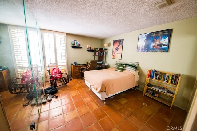 a bedroom with furniture and a large window