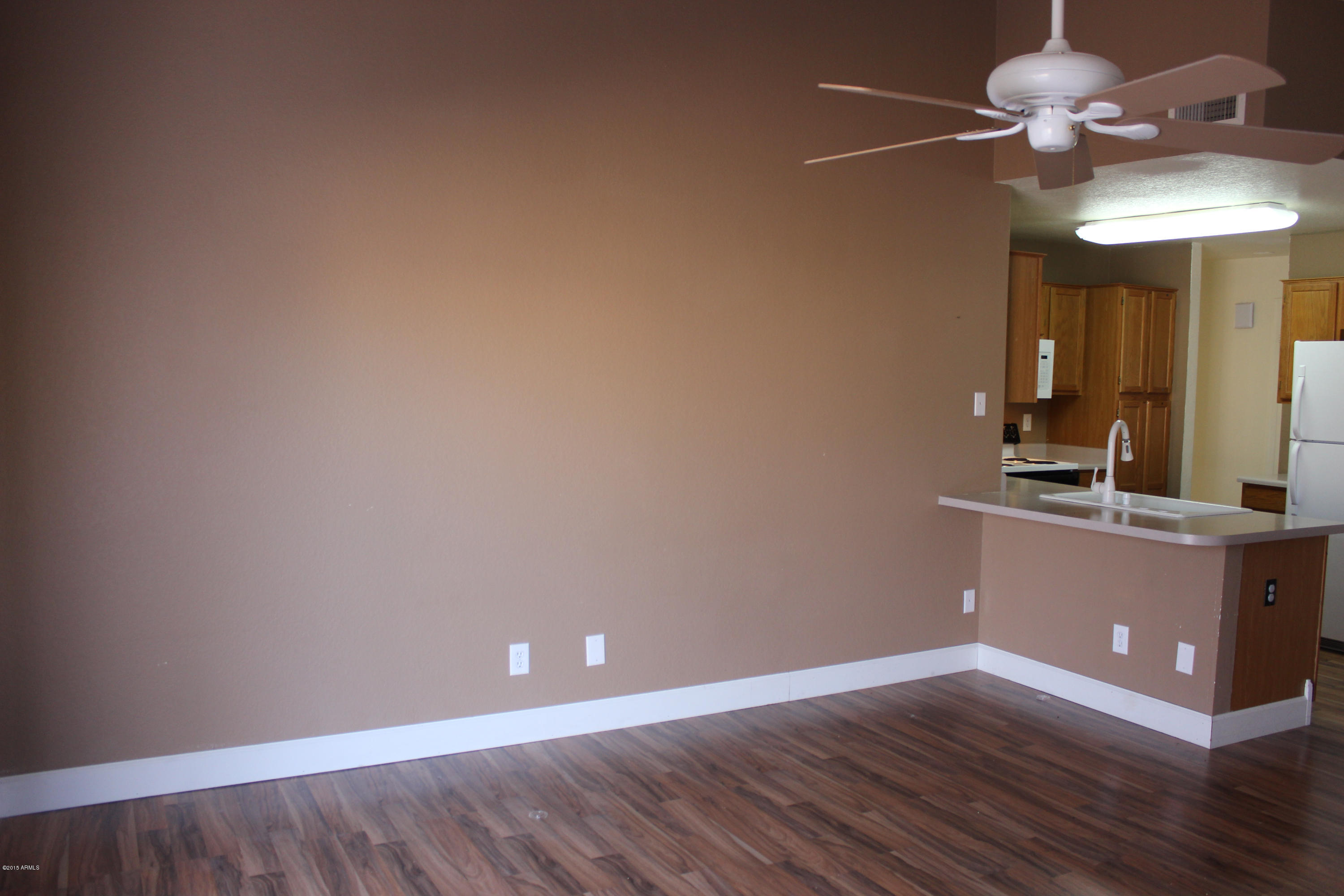 5028 Casper Road Mesa, AZ 85205 - Photo 12 of 33 a view of room with a ceiling fan and wooden floor