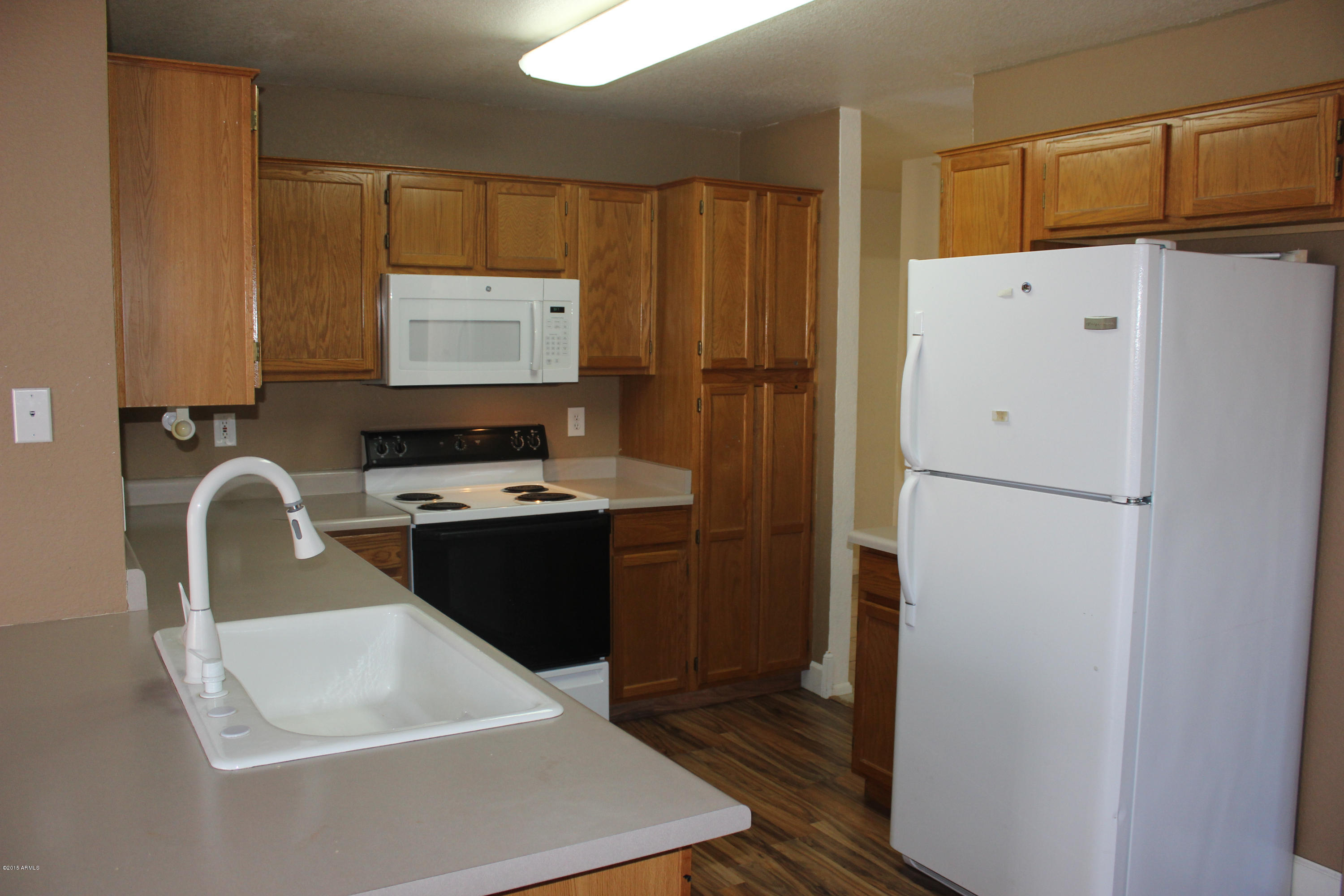5028 Casper Road Mesa, AZ 85205 - Photo 13 of 33 a kitchen with a refrigerator and a sink