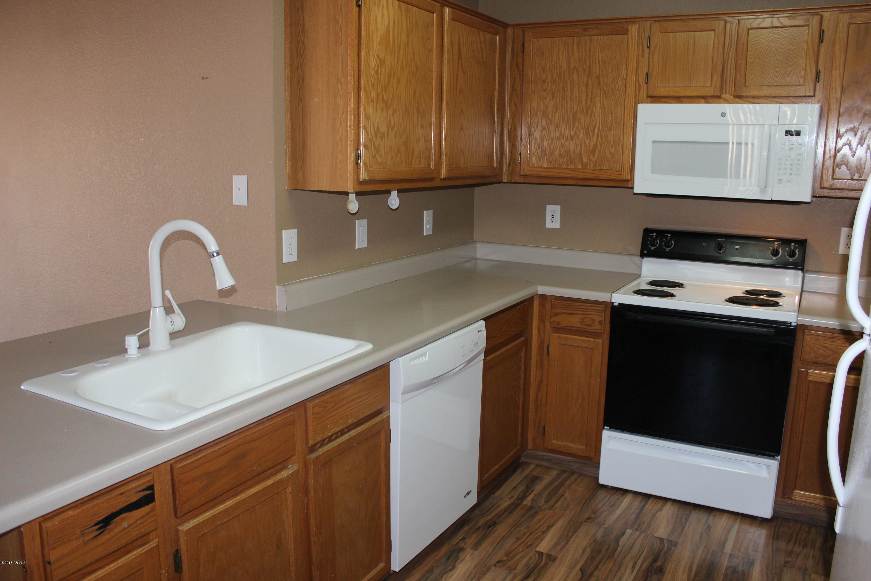 5028 Casper Road Mesa, AZ 85205 - Photo 14 of 33 a kitchen with a sink cabinets and stainless steel appliances