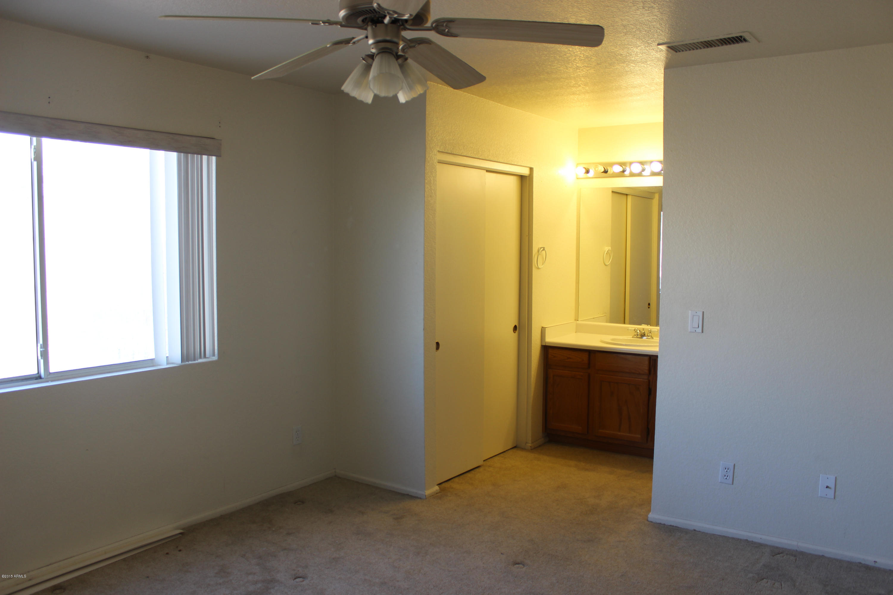 5028 Casper Road Mesa, AZ 85205 - Photo 22 of 33 an empty room with windows and entrance