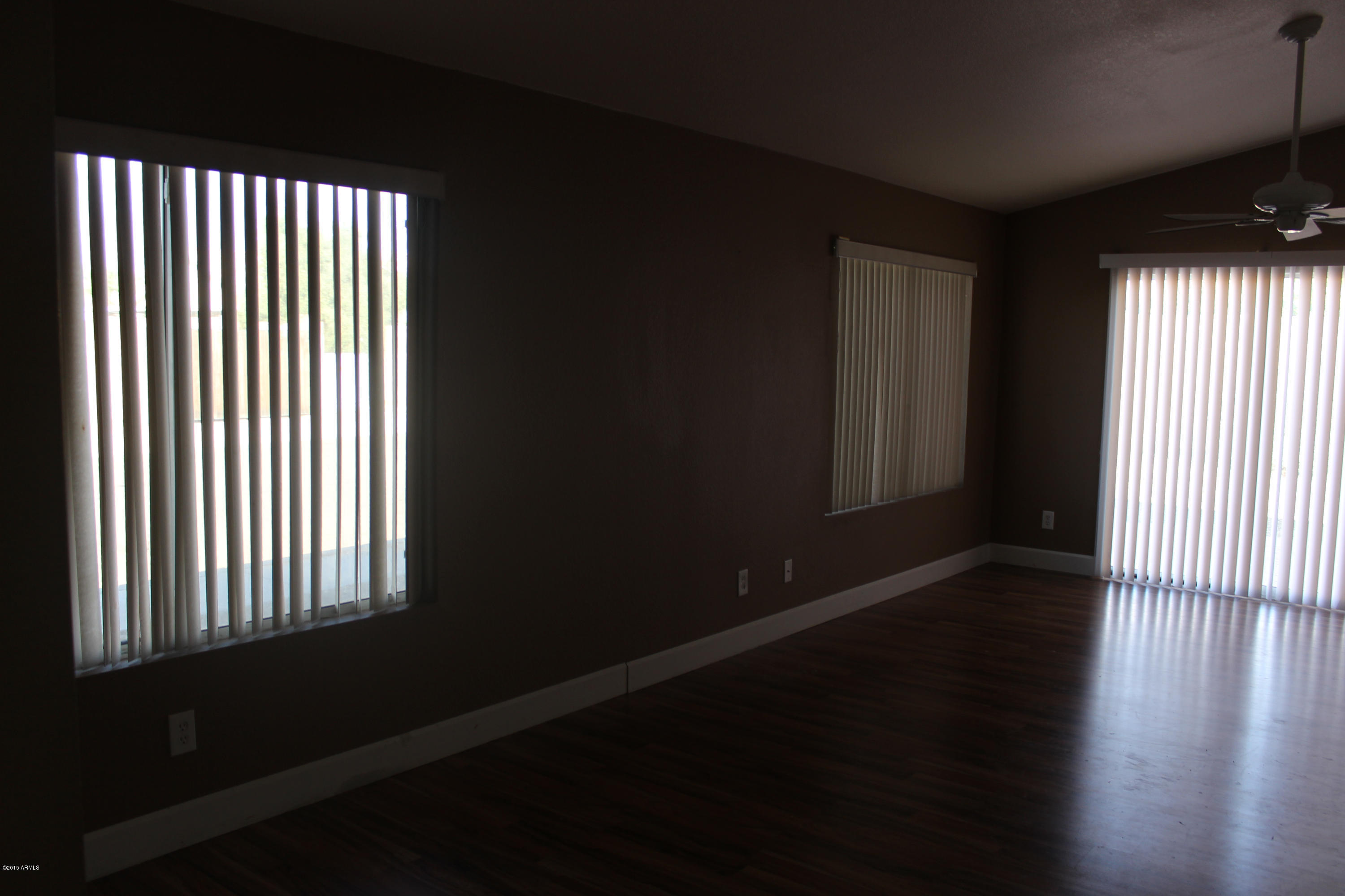 5028 Casper Road Mesa, AZ 85205 - Photo 9 of 33 a view of wooden floor and windows in a room