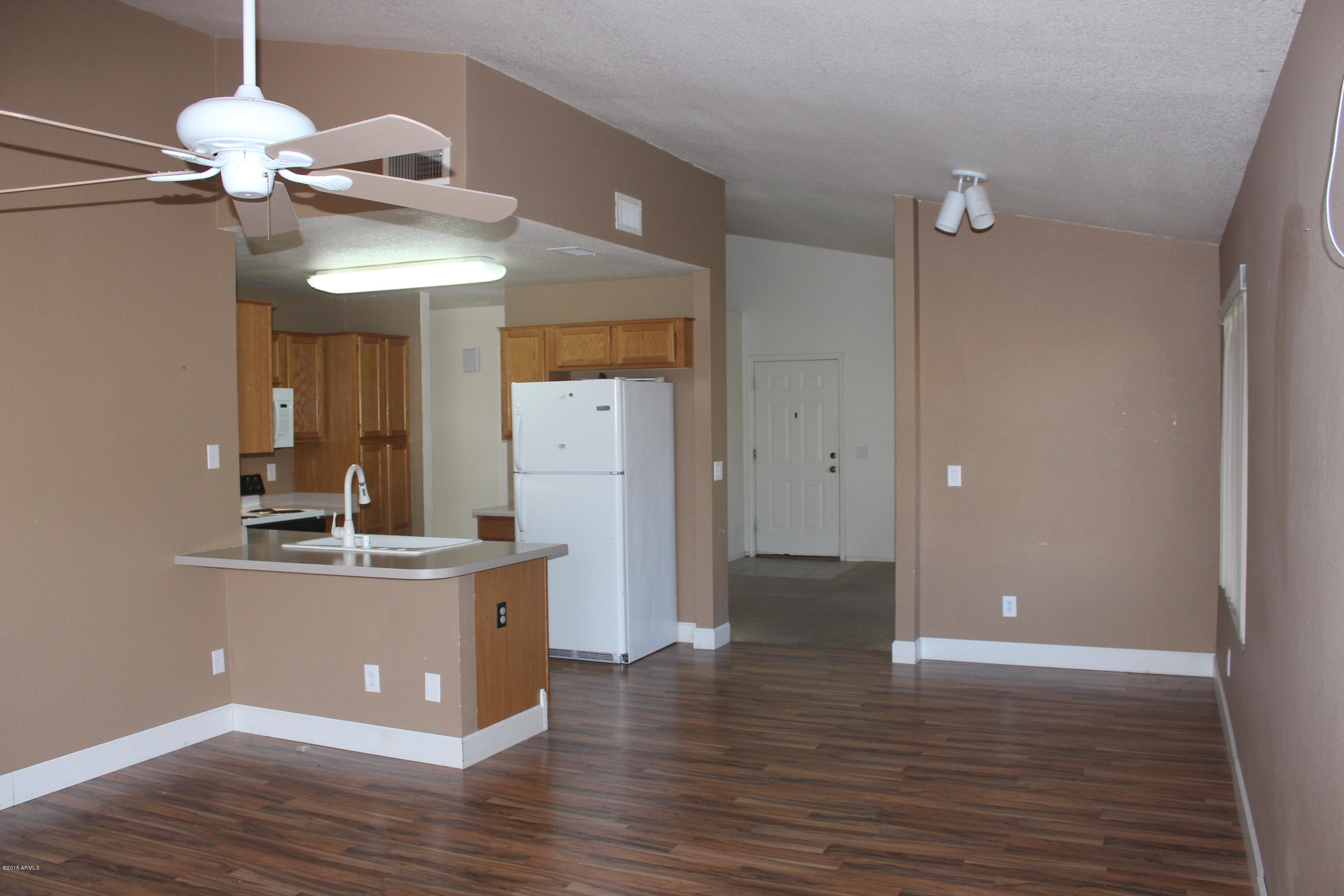 5028 Casper Road Mesa, AZ 85205 - Photo 10 of 33 a view of a kitchen with a sink and wooden floor