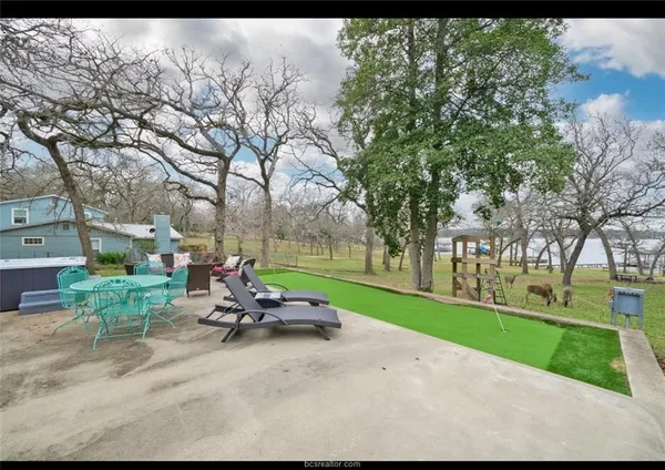 a view of a patio with couches table and chairs and potted plants