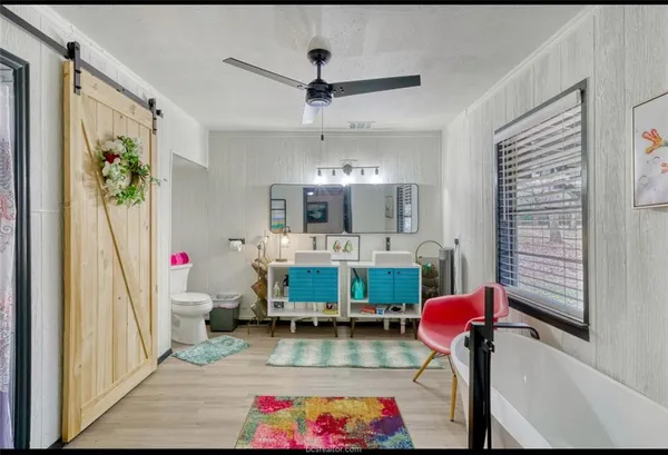 a view of room with cabinets and flat screen tv