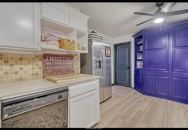 a kitchen with sink refrigerator and window