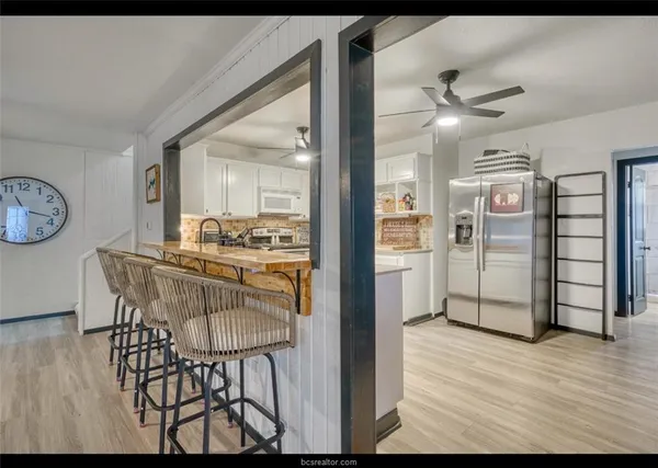 a view of a dining room with furniture and a chandelier