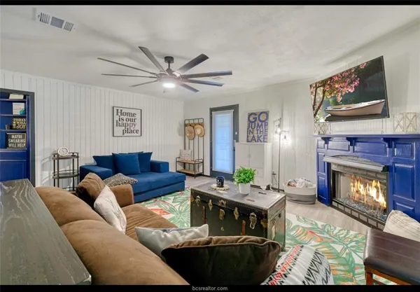 a living room with furniture and a floor to ceiling window