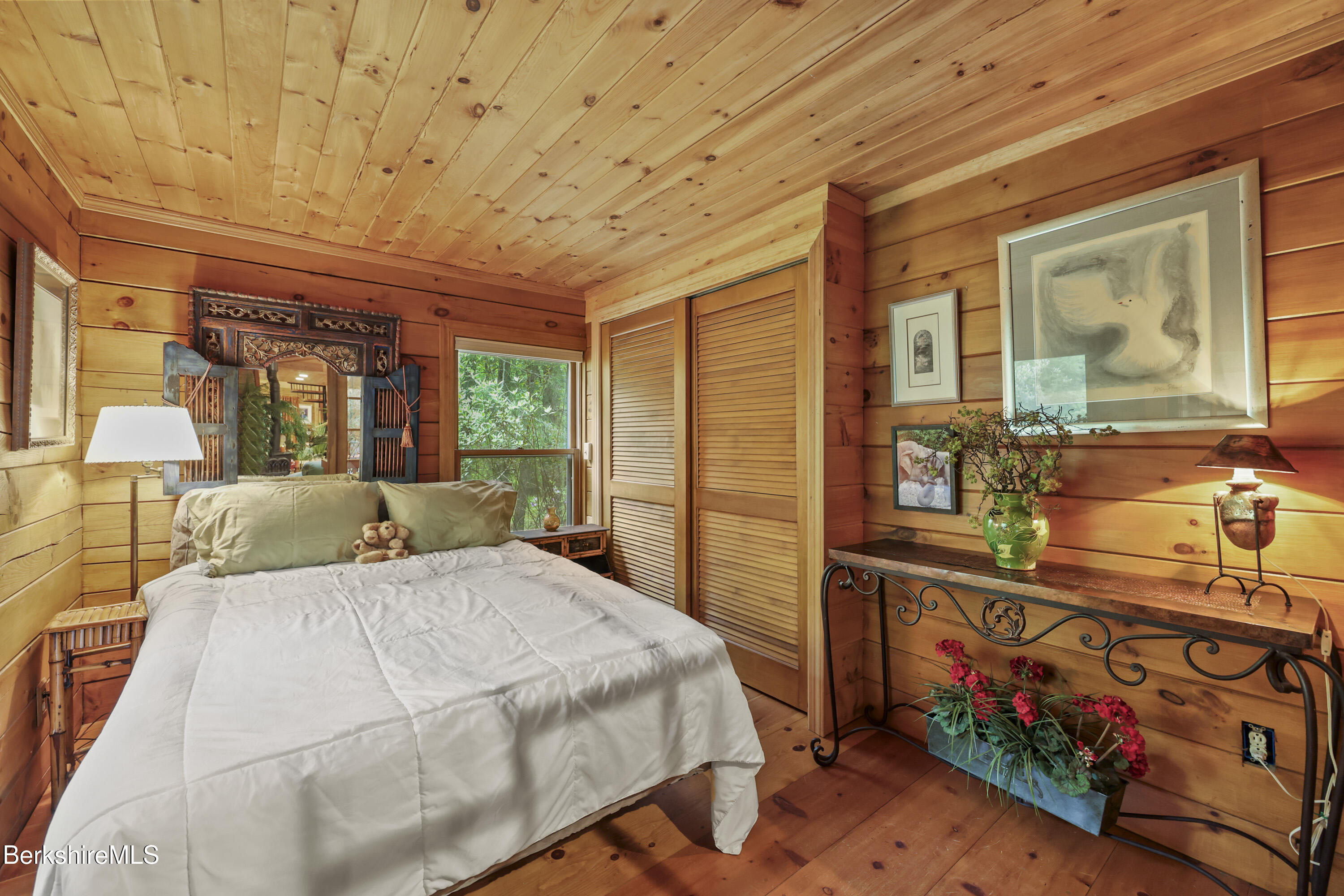 236 Surriner Road Becket, MA 01223 - Photo 28 of 45 a bedroom with a bed and wooden floor