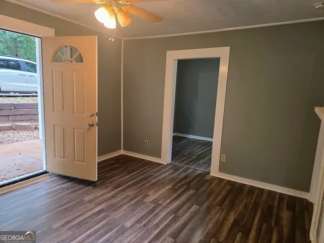 an empty room with wooden floor and a window