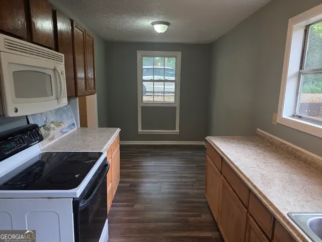 a kitchen with a stove sink and microwave