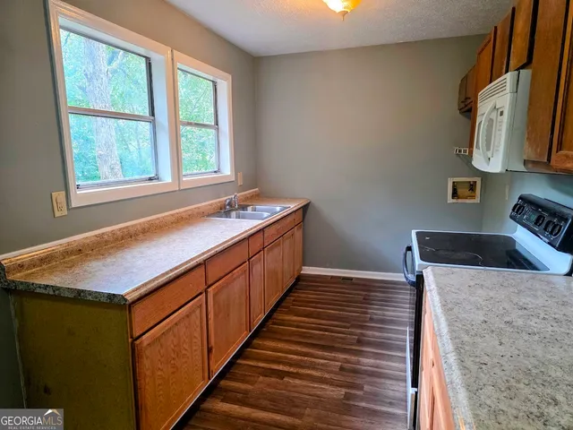 a kitchen with wooden cabinets and a sink