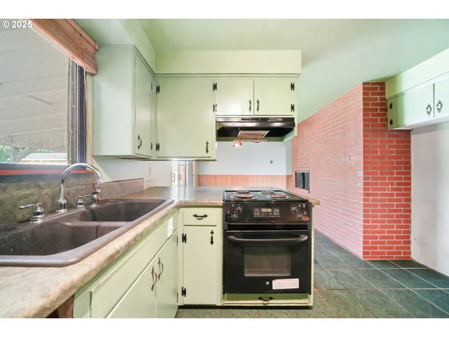 a kitchen with a stove and a sink