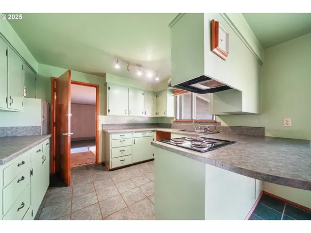 a kitchen with stainless steel appliances granite countertop a stove and a sink