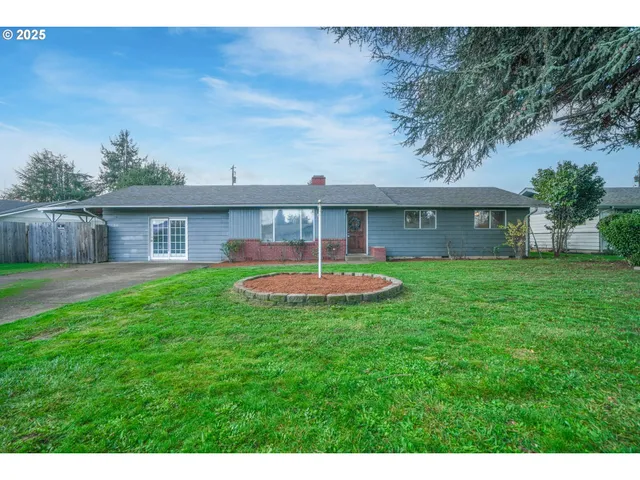 a front view of a house with a yard table and chairs