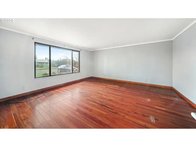 a open hall with wooden floor and windows