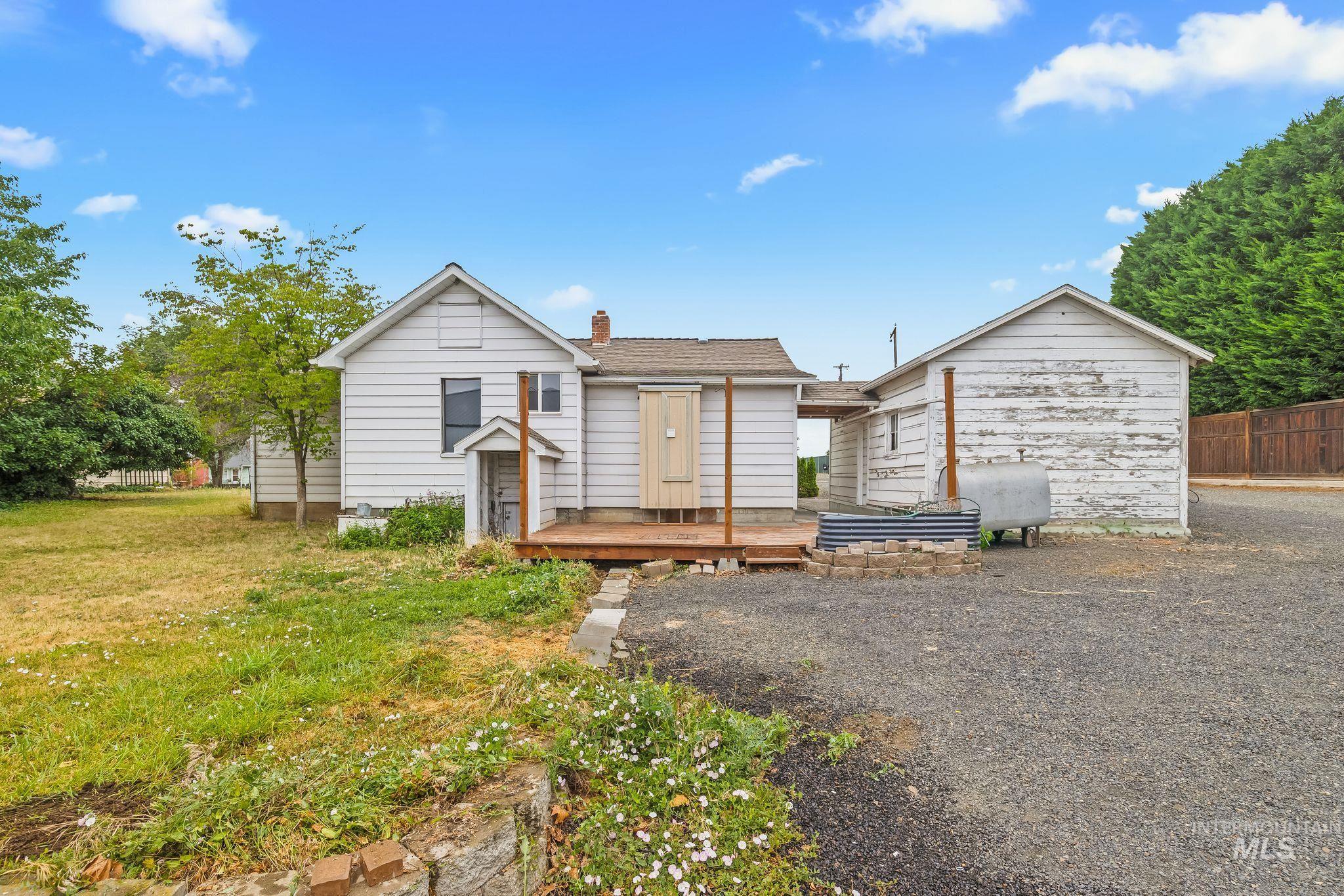 2255 Appleside Boulevard Clarkston, WA 99403 - Photo 30 of 41 Gravel driveway with a wooden deck and an adjacent outbuilding featuring white horizontal siding