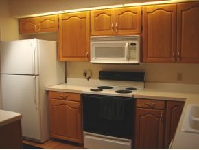 1017 Forest Hylands Road, Unit 1 Prescott, AZ 86303 - Photo 5 of 6 a kitchen with a sink a refrigerator and cabinets