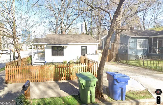 a view of a house with a chairs in a patio