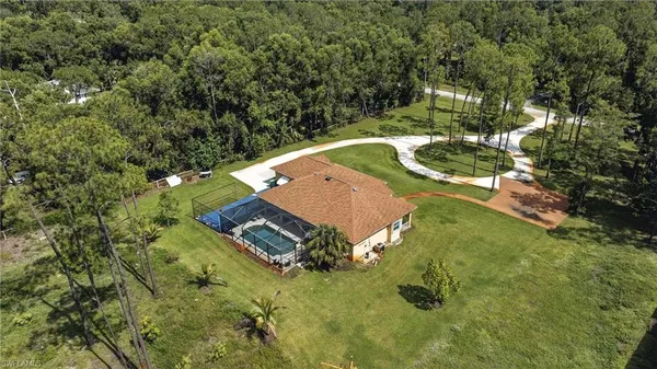 an aerial view of a house with a yard