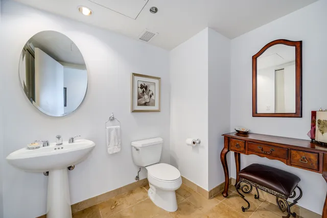 a spacious bedroom with a bed a couch and a large window