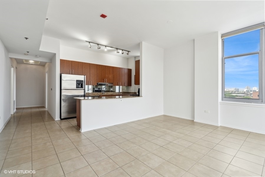 1201 West Adams Street, Unit 701 Chicago, IL 60607 - Photo 11 of 29 a kitchen with cabinets and a refrigerator