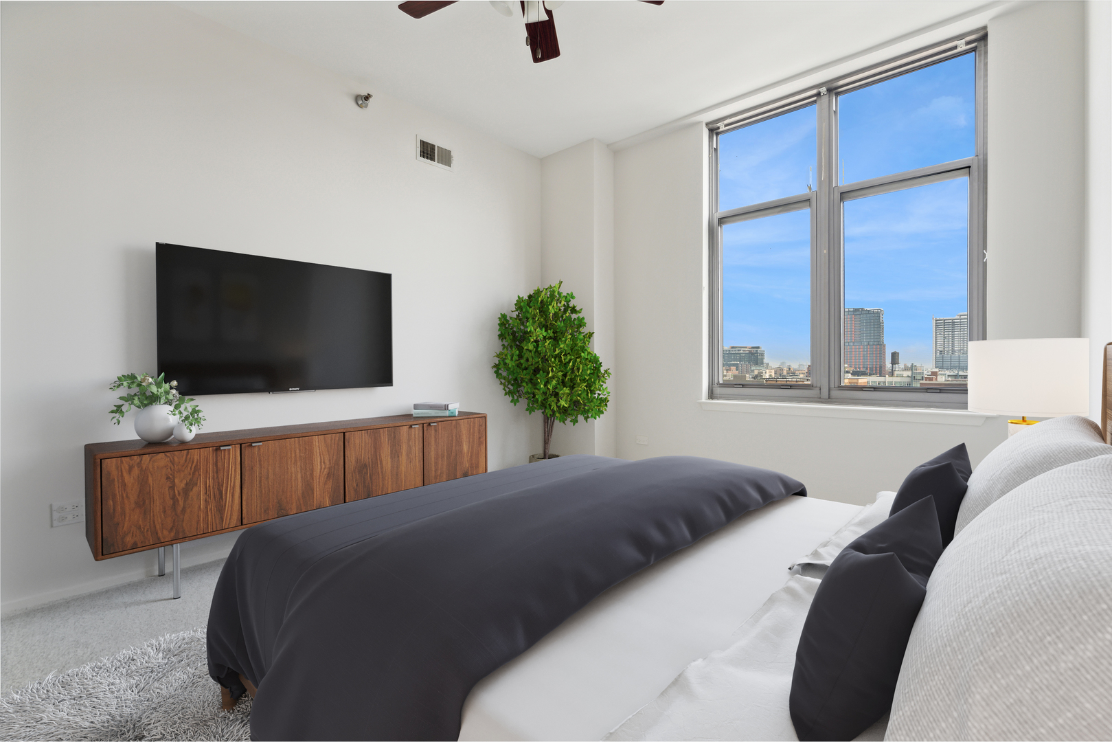 1201 West Adams Street, Unit 701 Chicago, IL 60607 - Photo 15 of 29 a bedroom with a bed and a flat screen tv