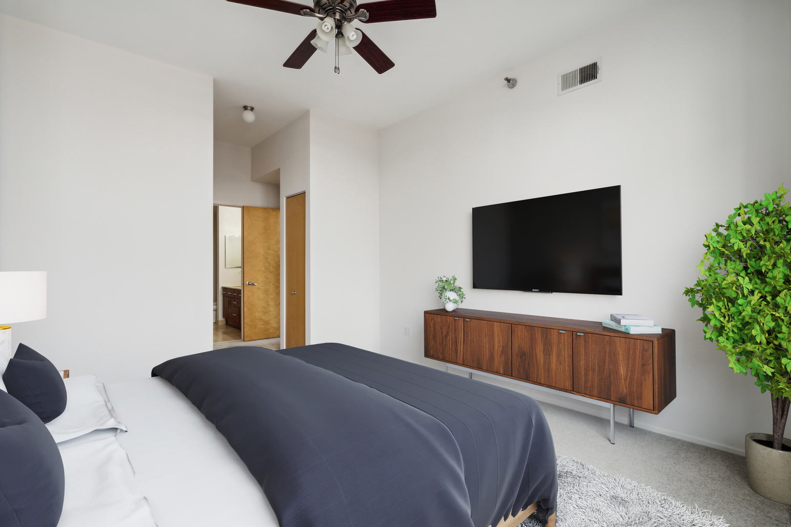 1201 West Adams Street, Unit 701 Chicago, IL 60607 - Photo 17 of 29 a bedroom with a bed and a flat screen tv