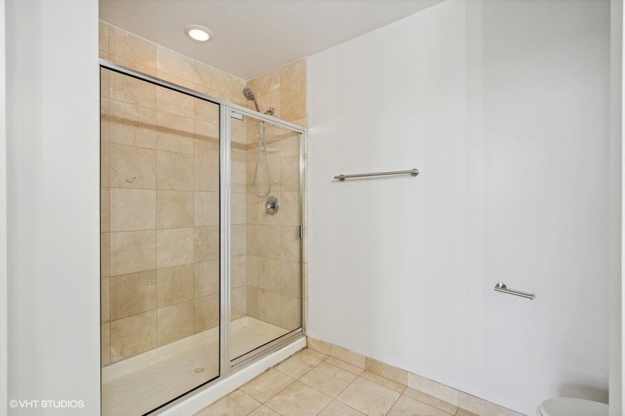 1201 West Adams Street, Unit 701 Chicago, IL 60607 - Photo 20 of 29 a bathroom with a glass shower door