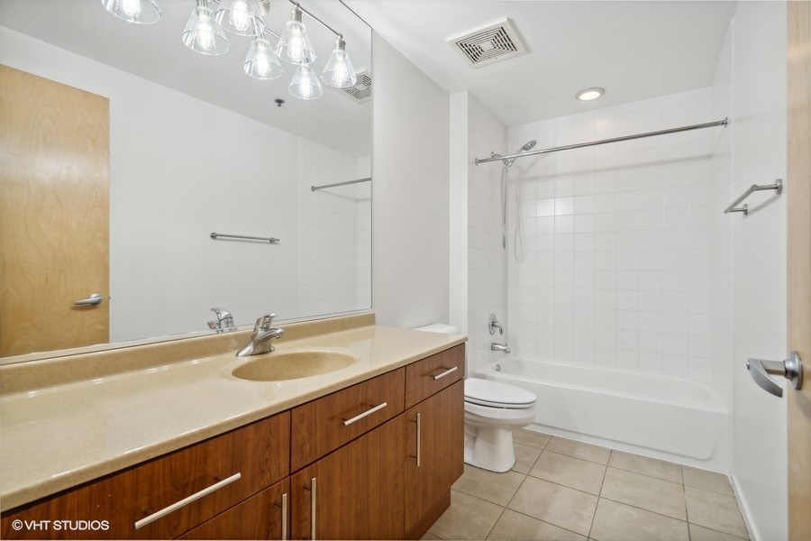 1201 West Adams Street, Unit 701 Chicago, IL 60607 - Photo 26 of 29 a bathroom with a sink a toilet and shower