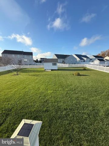 a view of a deck with table and chairs with wooden floor and fence