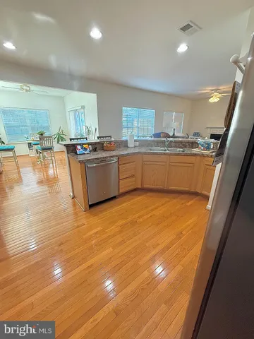 a kitchen with stainless steel appliances granite countertop a sink and cabinets