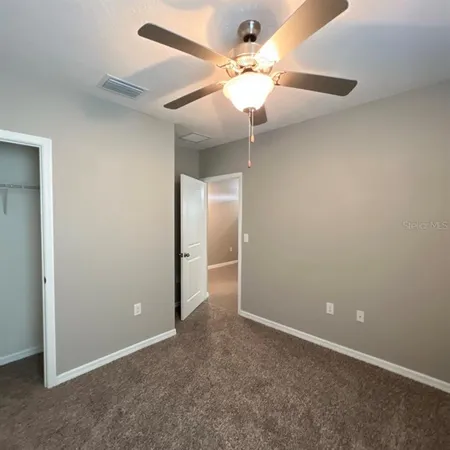 an empty room with a fan and a fan