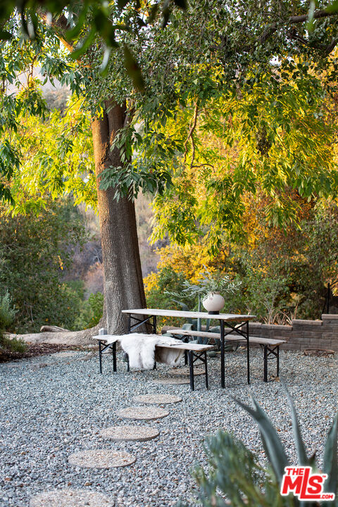 243 Taos Road Altadena, CA 91001 - Photo 32 of 32 a view of a wooden chairs and fire pit in the backyard
