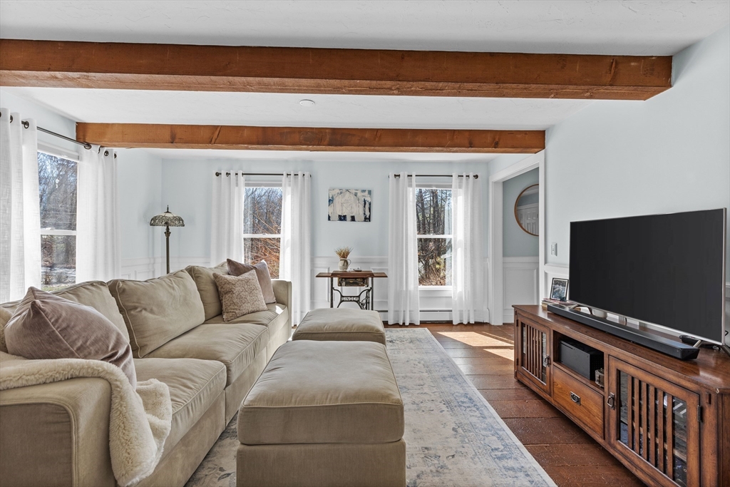 57 Whitewood Road Milford, MA 01757 - Photo 12 of 40 a living room with furniture and a flat screen tv