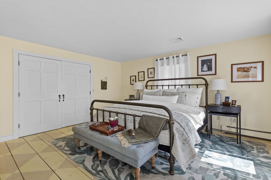 57 Whitewood Road Milford, MA 01757 - Photo 19 of 40 a bedroom with a bed and wooden floor