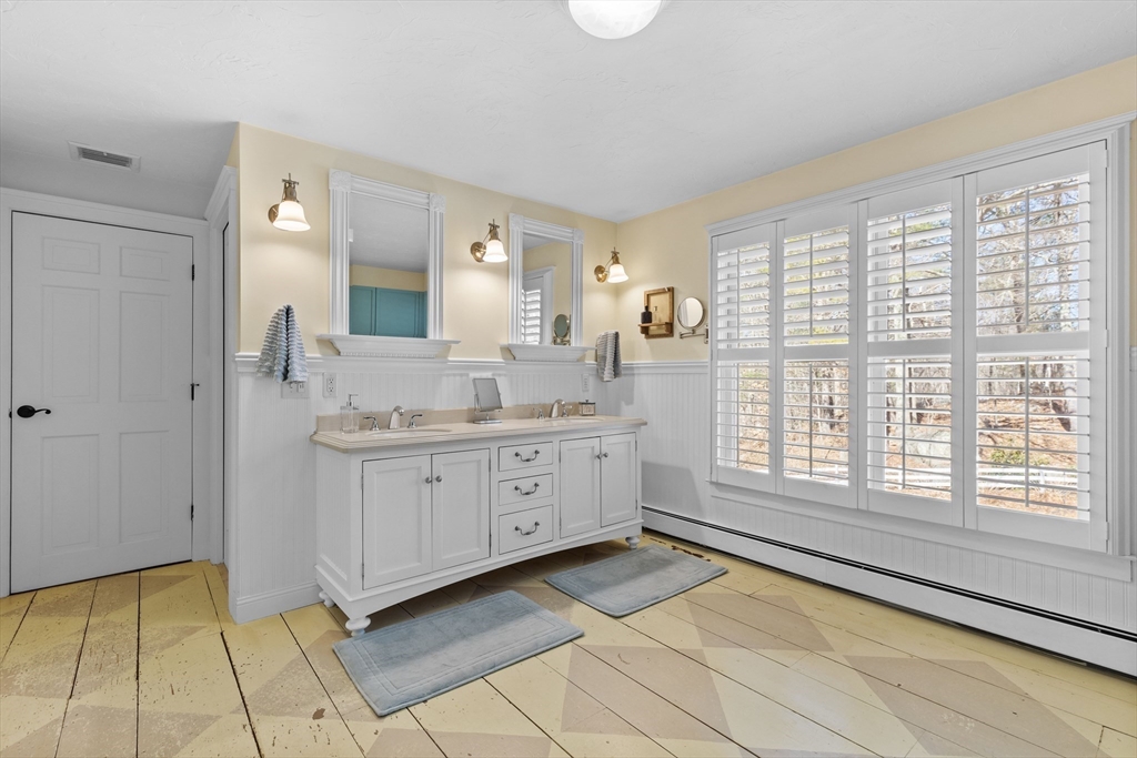 57 Whitewood Road Milford, MA 01757 - Photo 20 of 40 a spacious bathroom with a granite countertop sink mirror and next to a window