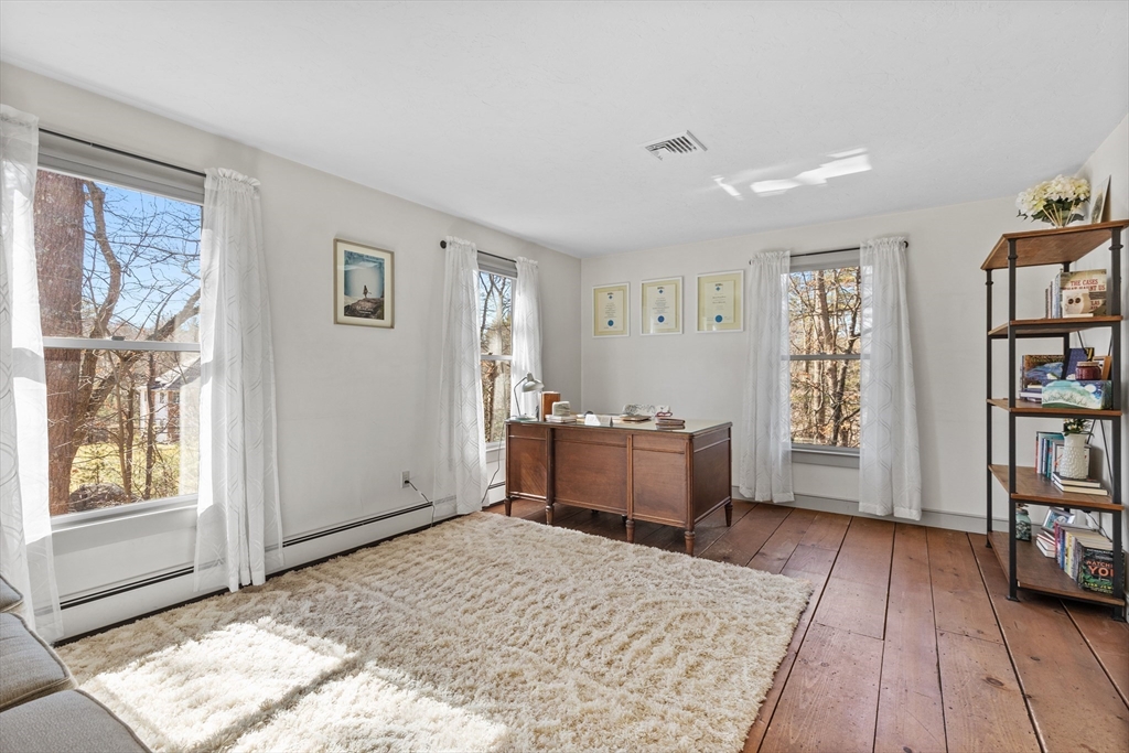57 Whitewood Road Milford, MA 01757 - Photo 27 of 40 a bedroom with furniture and a book shelf