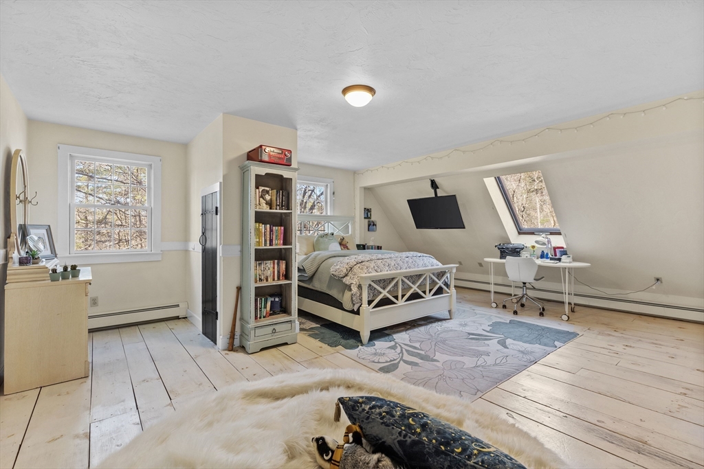 57 Whitewood Road Milford, MA 01757 - Photo 31 of 40 a bedroom with a bed and wooden floor