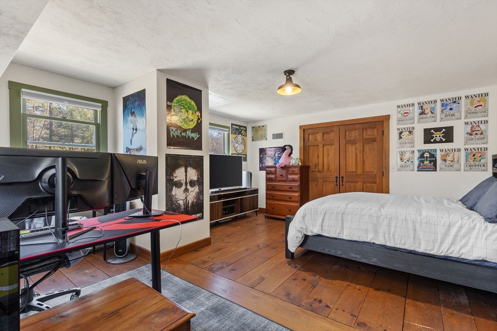 57 Whitewood Road Milford, MA 01757 - Photo 33 of 40 a bedroom with a bed and a bookshelf