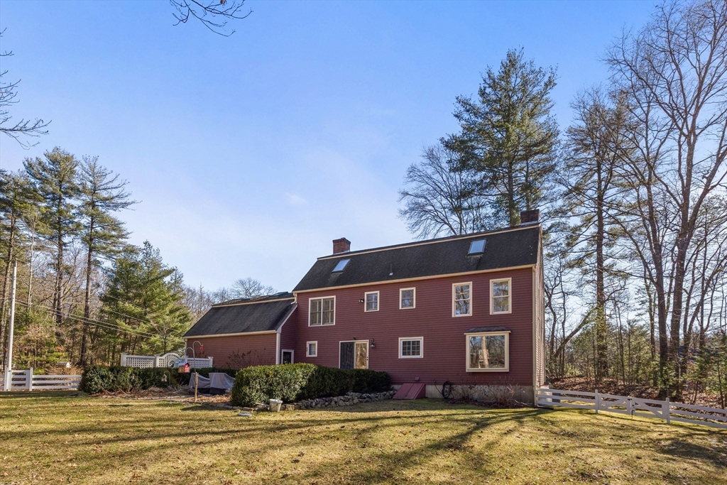 57 Whitewood Road Milford, MA 01757 - Photo 39 of 40 a view of a brick building next to a yard with large trees