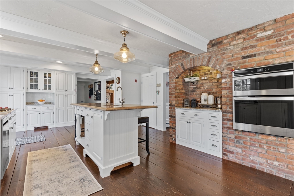 57 Whitewood Road Milford, MA 01757 - Photo 4 of 40 a living room with furniture and a flat screen tv