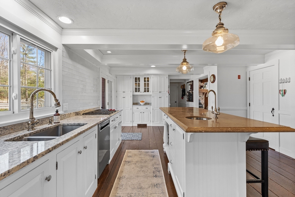 57 Whitewood Road Milford, MA 01757 - Photo 7 of 40 a large kitchen with stainless steel appliances granite countertop a sink and a stove