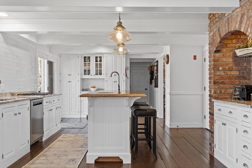 57 Whitewood Road Milford, MA 01757 - Photo 8 of 40 a kitchen with granite countertop a sink appliances a counter space and cabinets