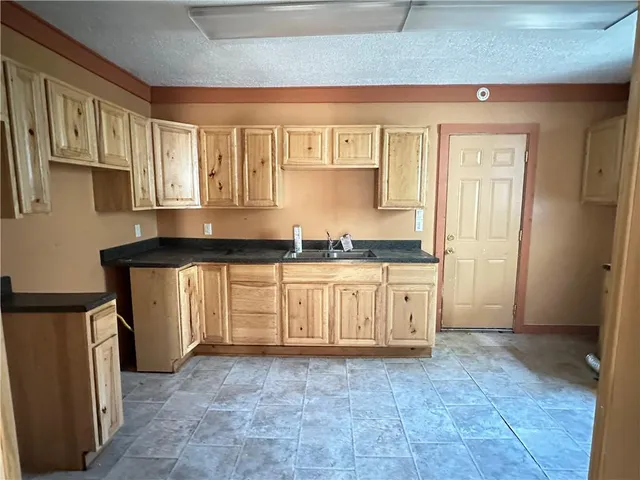 a view of a kitchen with granite countertop cabinets