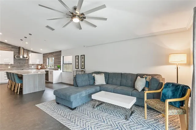 a living room with furniture and kitchen view