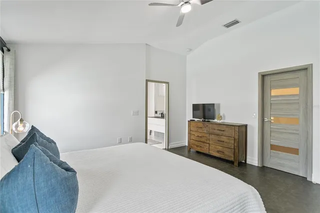 a bedroom with a bed and a chandelier